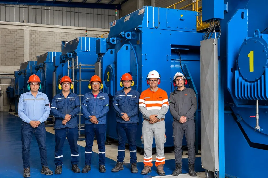 Technical team in front of test benches for high-power electric motors